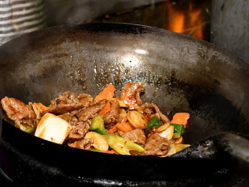 Szechuan beef stir-fried in a hot wok at Jade Cafe